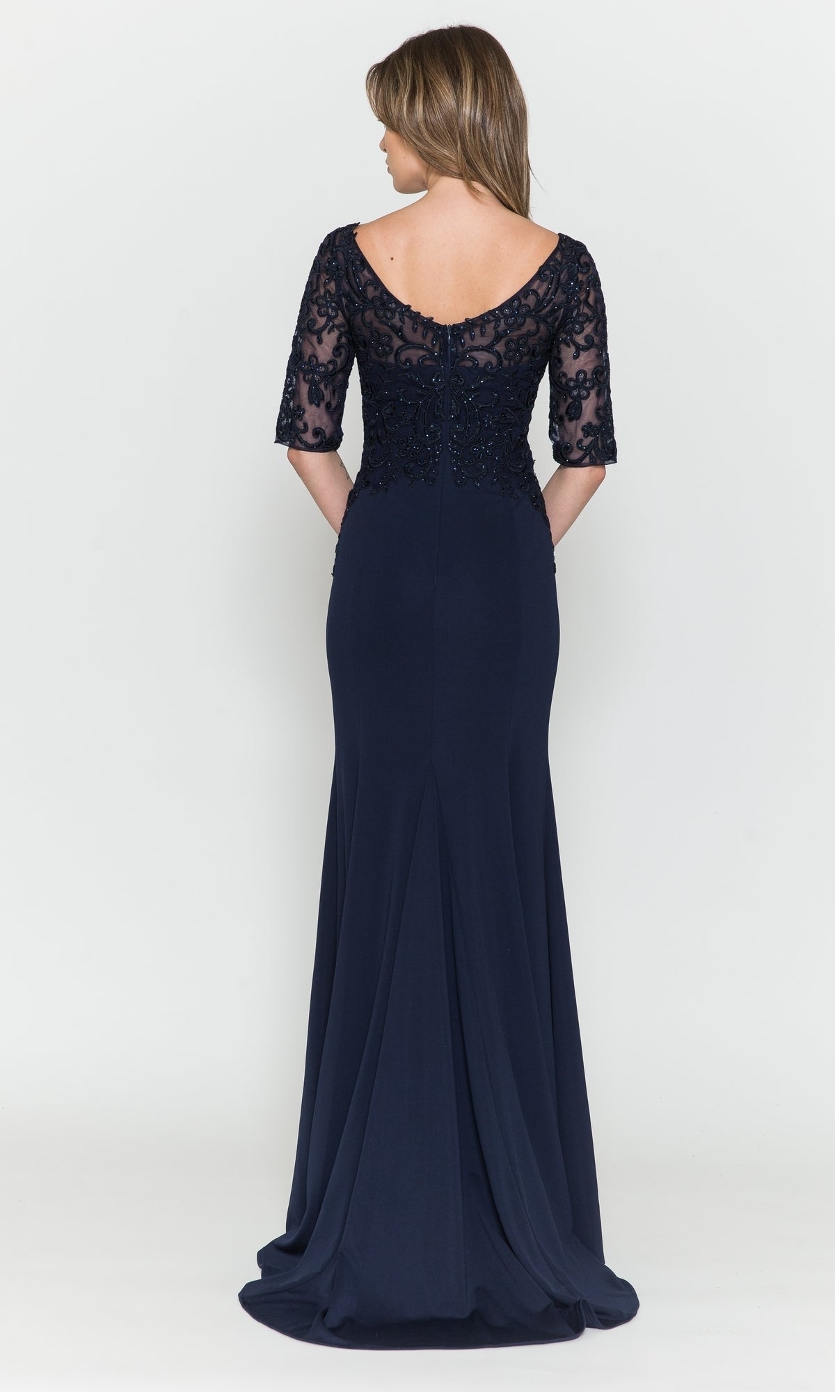 Woman shown from the back in the Embroidered Sheer-Sleeved Formal Prom Dress 8560, a navy blue gown featuring lace and bead detailing on the upper bodice and sleeves, set against a plain white background.